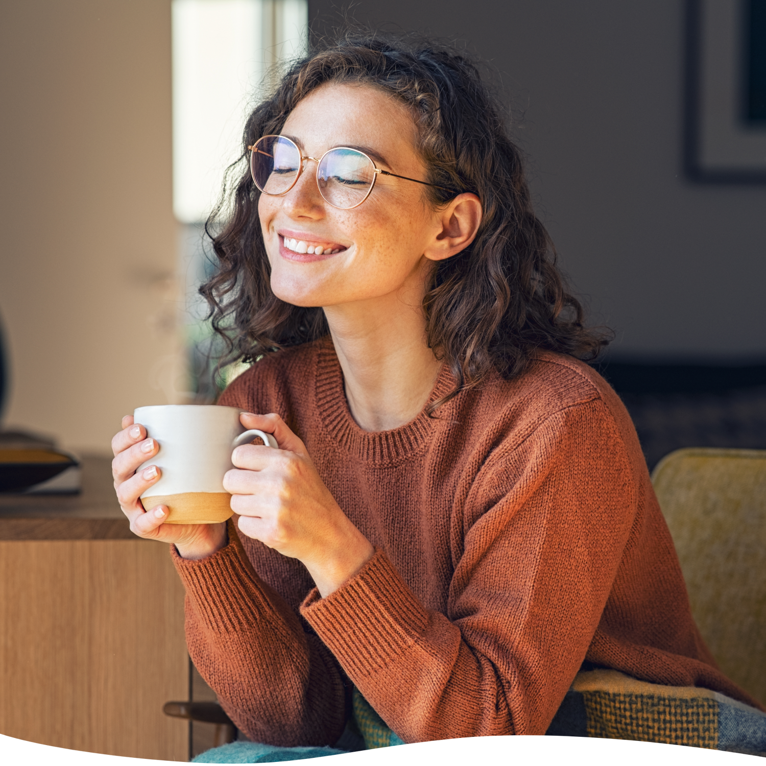 a girl smiling while holding a cup of tea